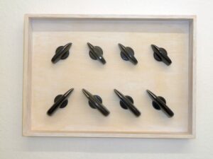 Tom Albrecht: Ein Aus, 2009, Berlin, 43 x 31 x 4 cm, Eight switch knobs 60s in wooden frame Works